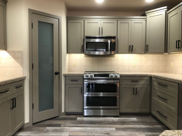 Green kitchen cabinets painted with smooth factory finish