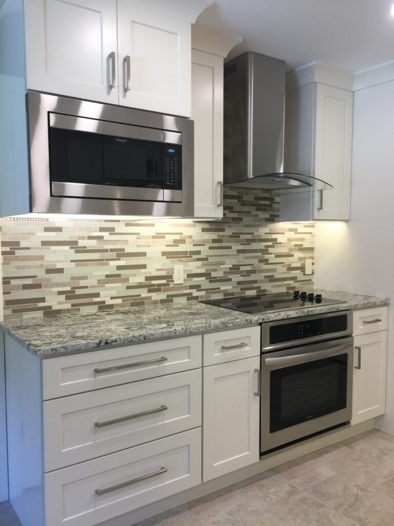 Finished kitchen cabinets with new paint and backsplash