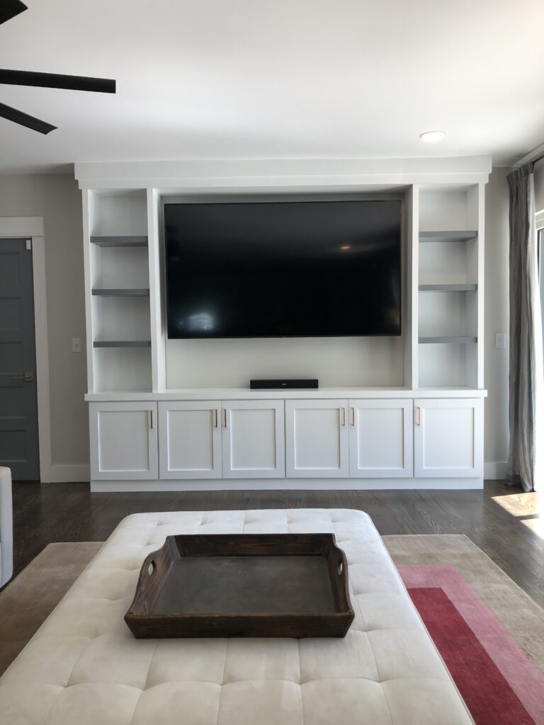 Built-in living room cabinets and shelving painted bright white