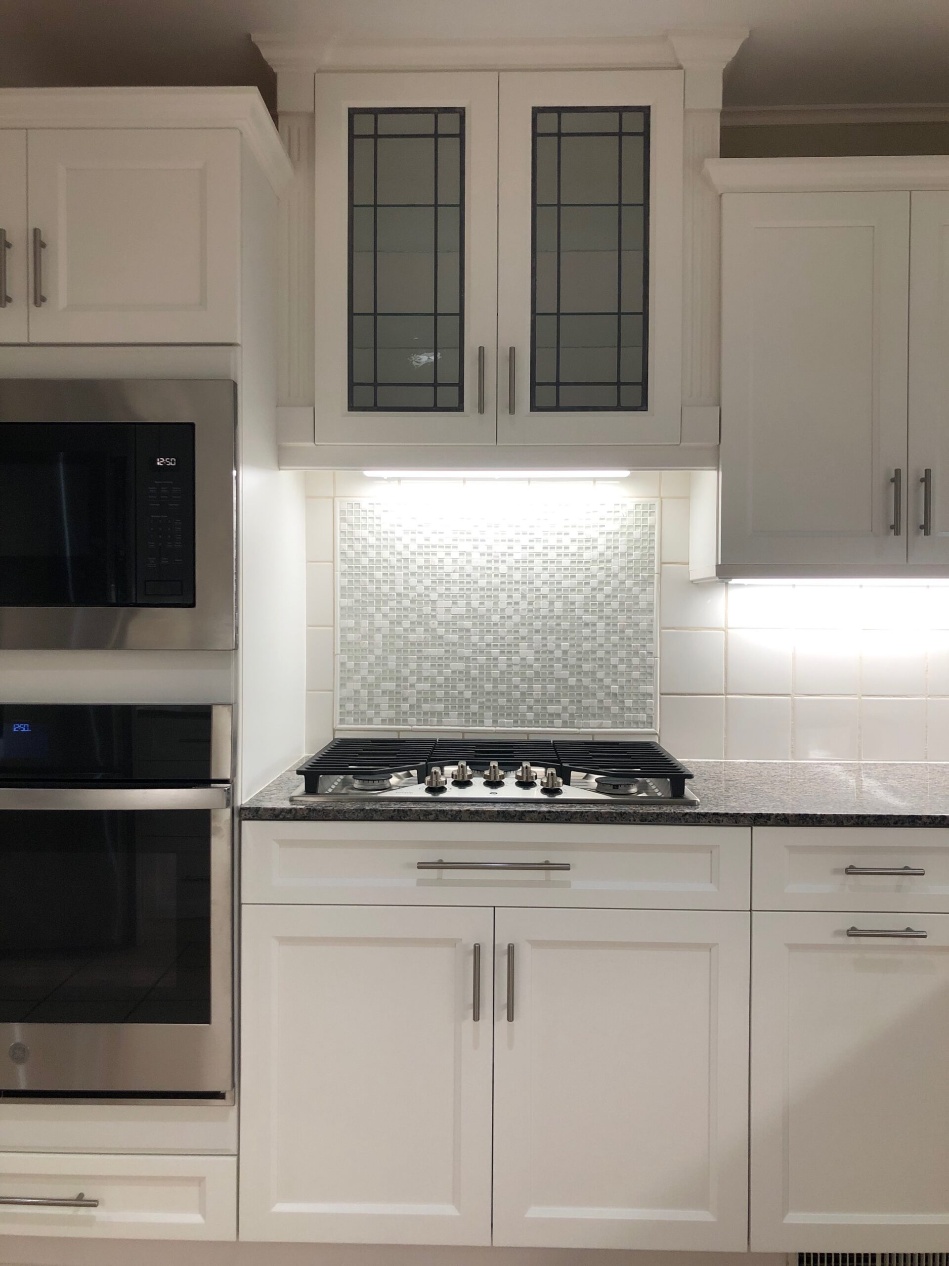White kitchen cabinets professionally painted and refinished in Tulsa by Zest
