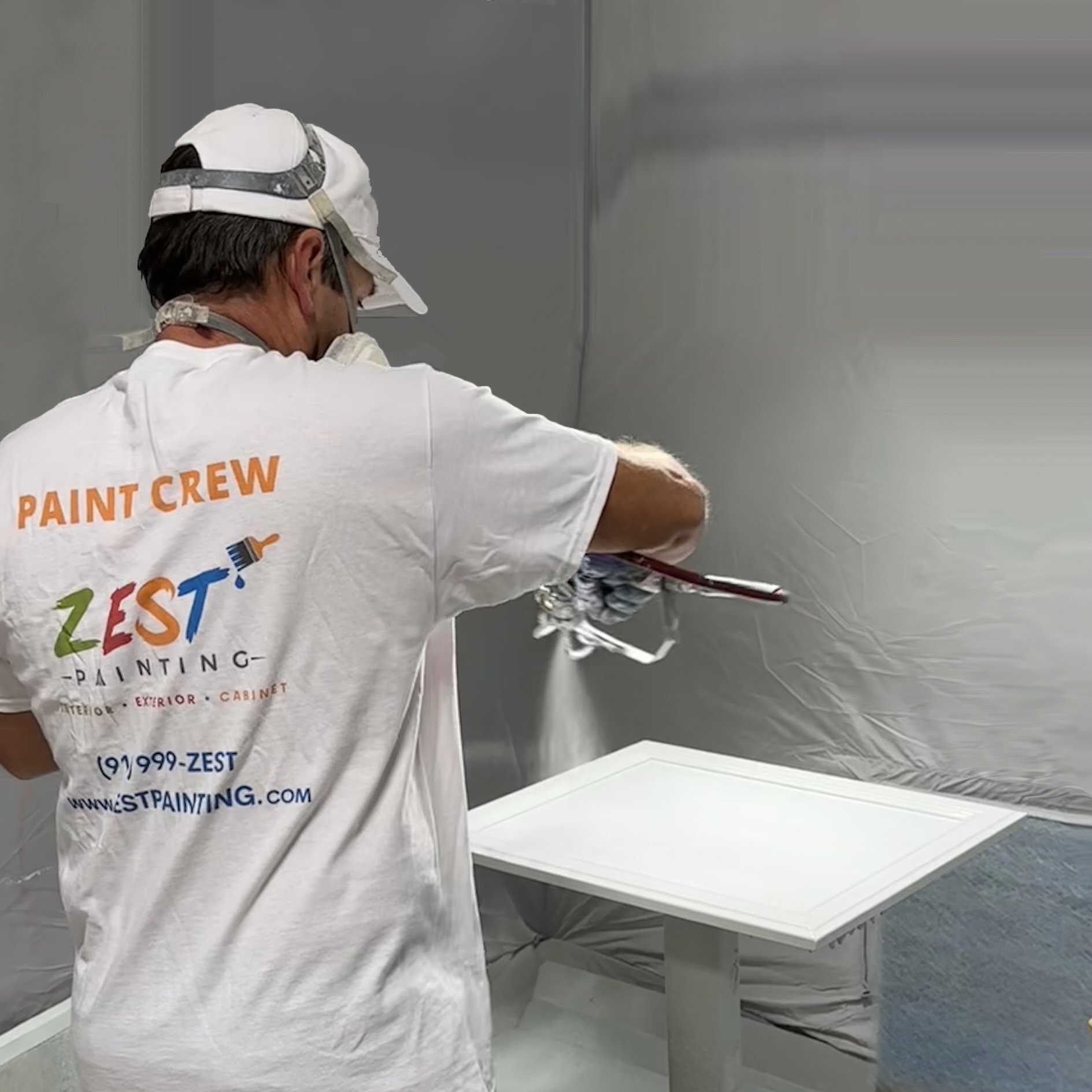Zest Painting crew spray painting cabinet doors in its controlled workshop in Tulsa